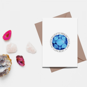 September birthstone card on a table with gemstones 